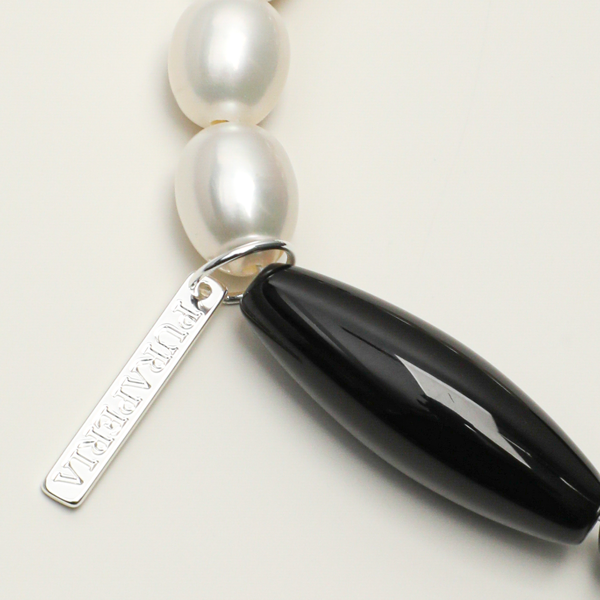 Black agate barrel bead and silver-plated 316L stainless steel engraving tag detail