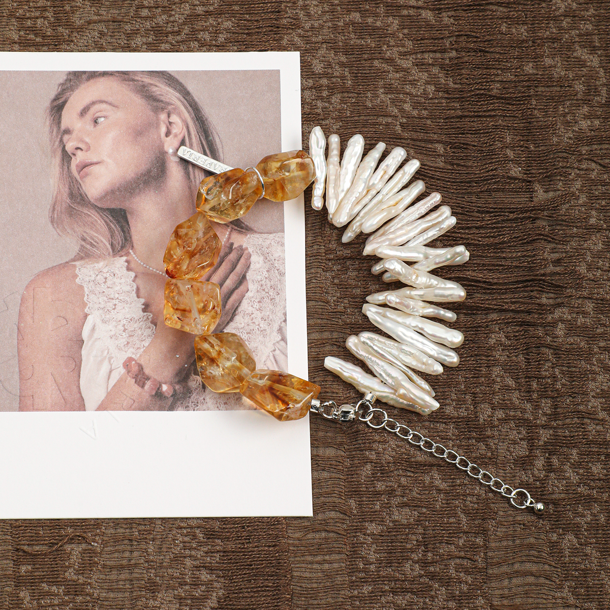Citrine and freshwater pearl bracelet styled on a textured background